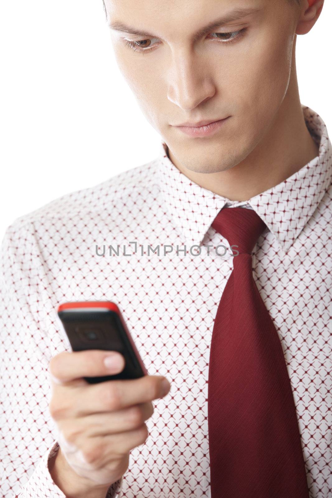 Businessman on a white background holding cellular phone and typing SMS
