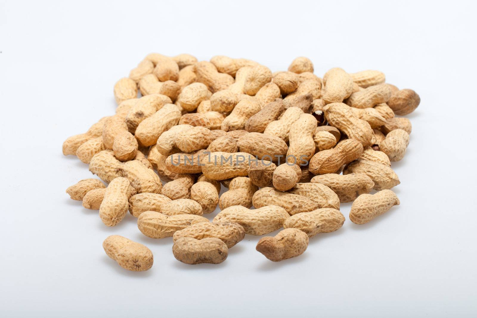 
Dried peanuts in closeup on the white background