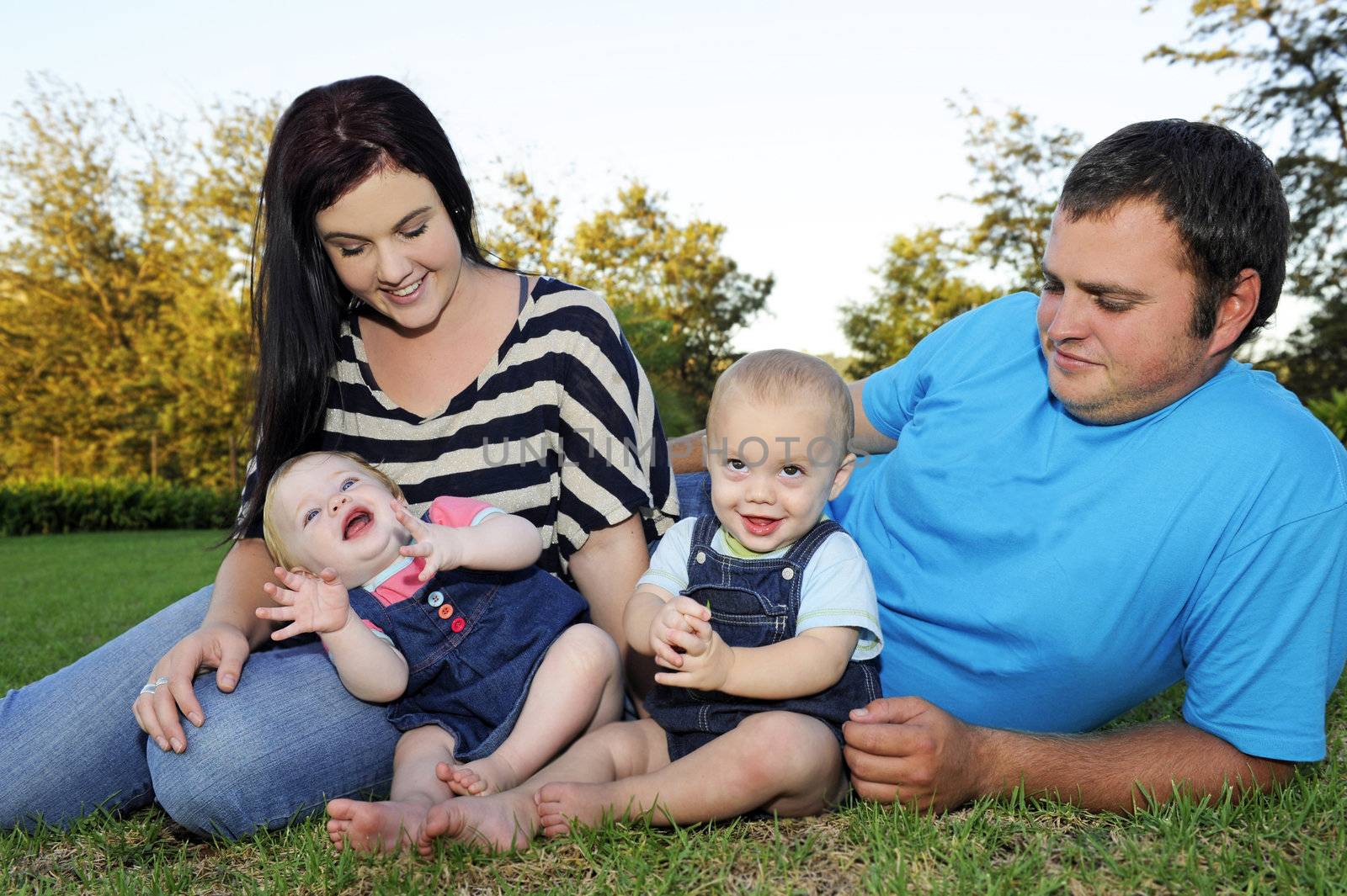 Beautiful young family with twin babies