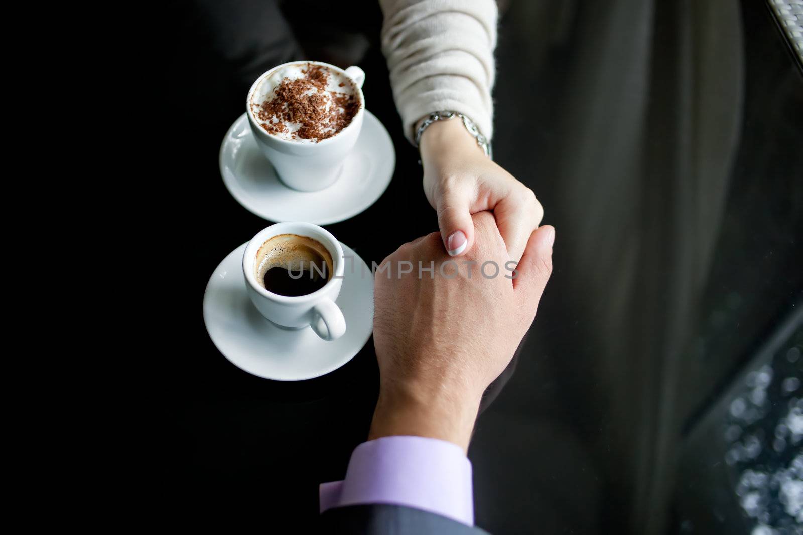 Concept of male and female hands, love and coffee