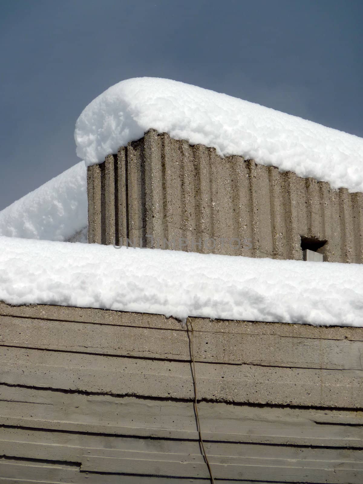 concrete wall covered with snow