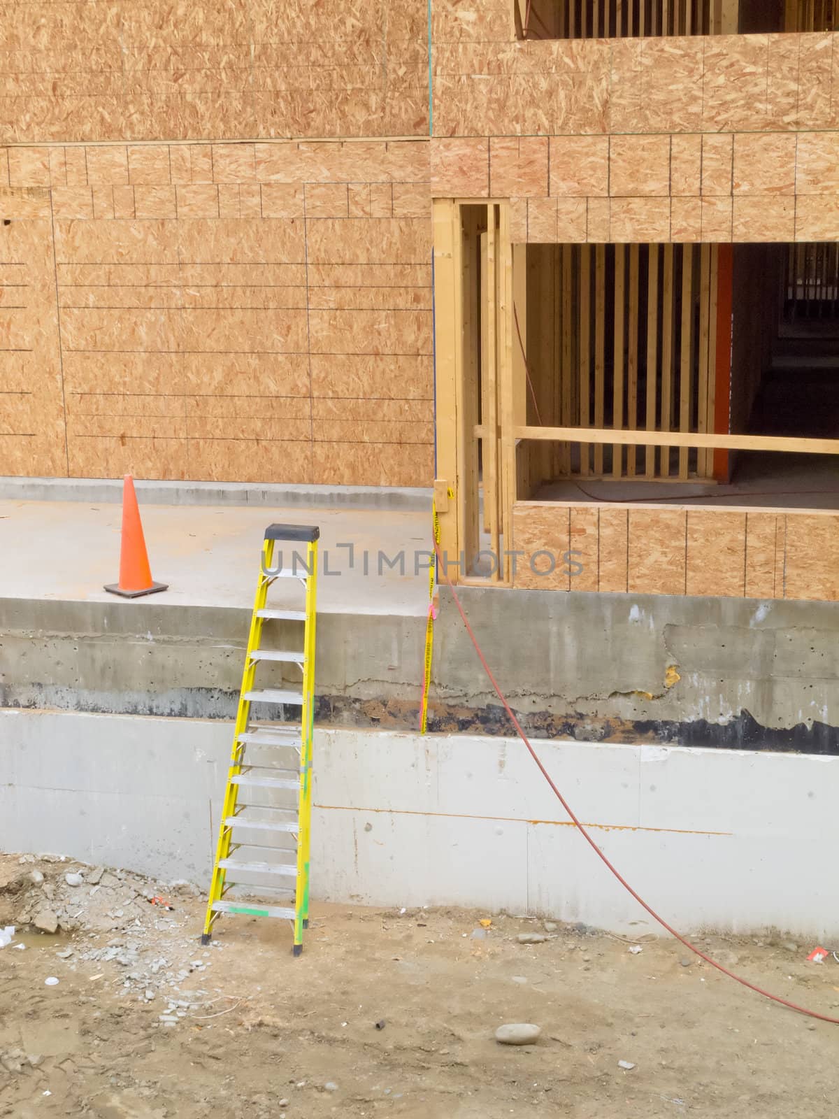 Exterior view of new home construction with still empty window openings being a deserted building site like after construction company went bankrupt