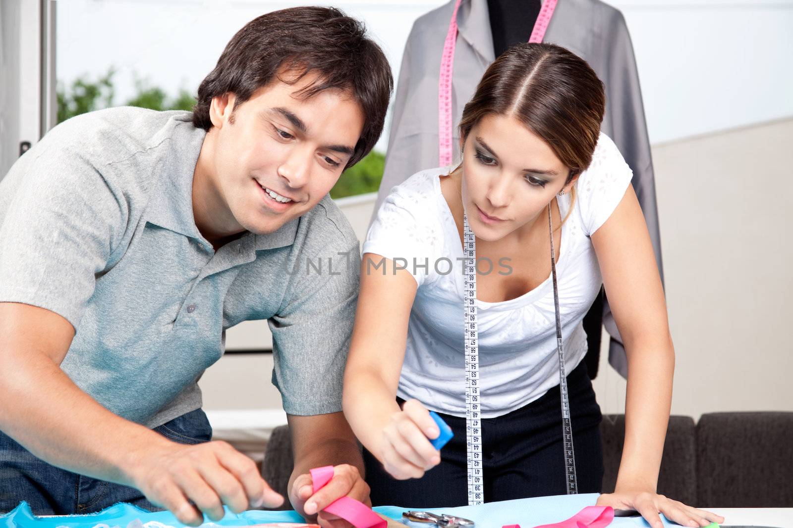 Two fashion designer working together at work place.