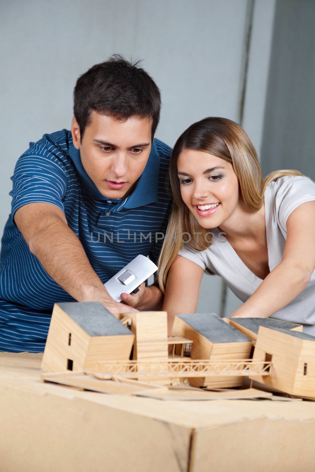 Couple Working On Model House by leaf
