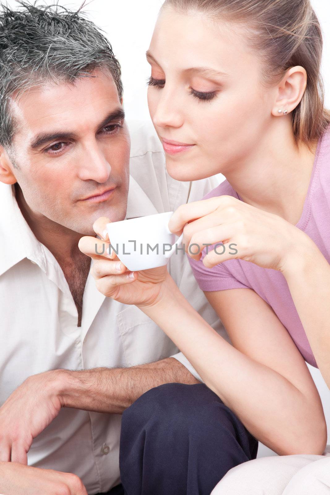 Attractive couple smelling cup of warm coffee