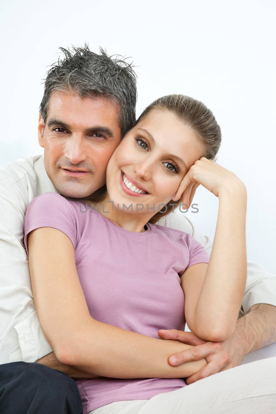 Portrait of an affectionate couple embracing over white background