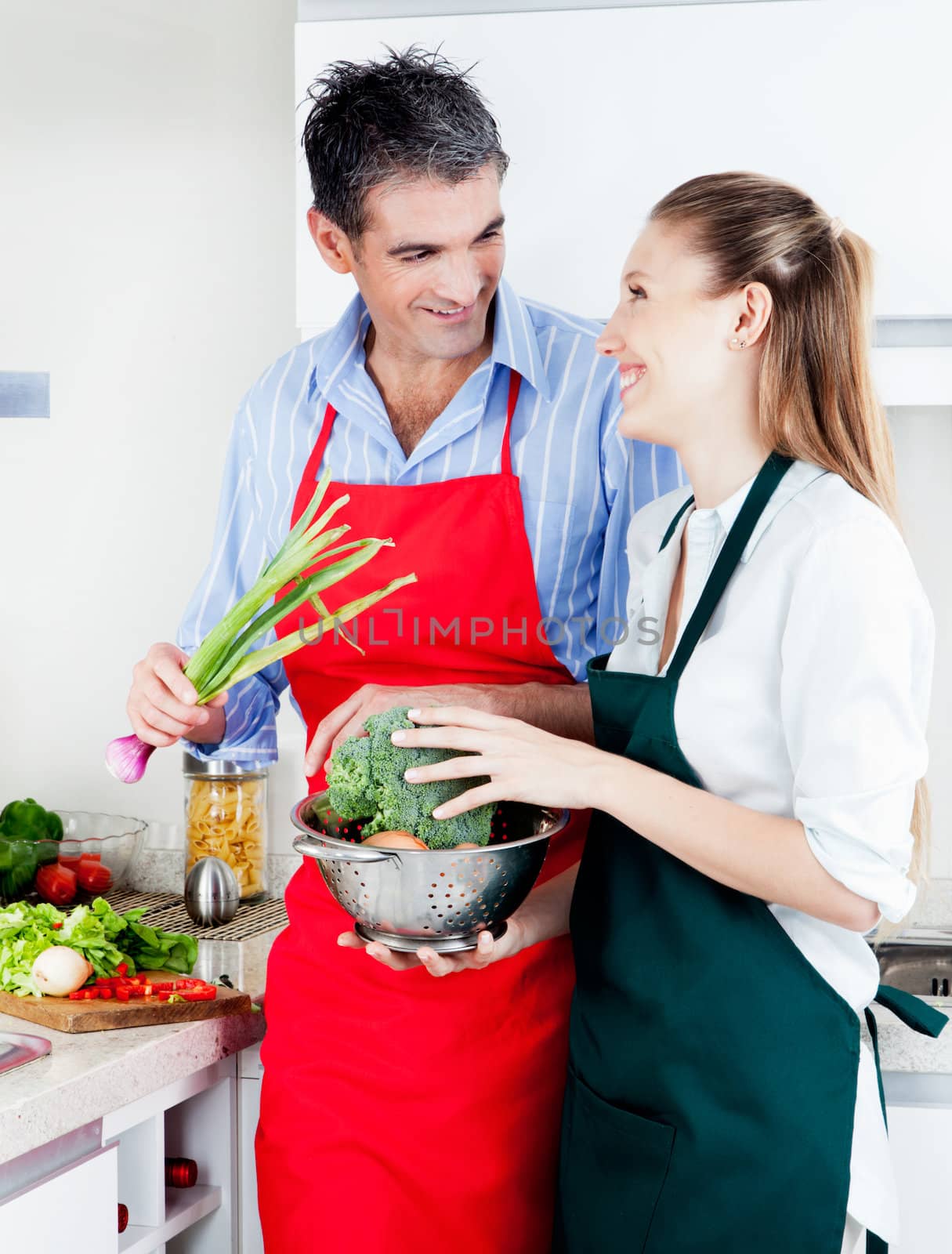 Man and Woman Cooking in Kitchen by leaf