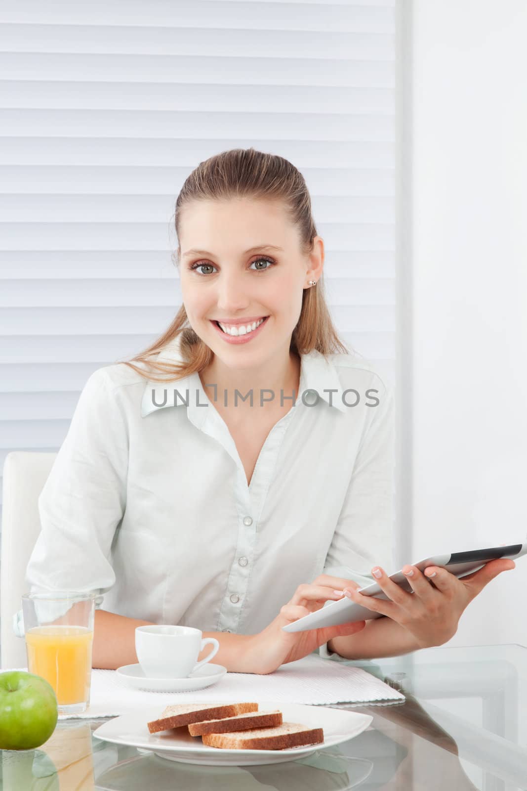 Woman Holding Digital Tablet by leaf