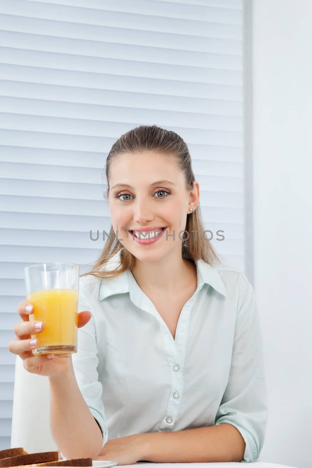 Happy Businesswoman Holding Orange Juice by leaf