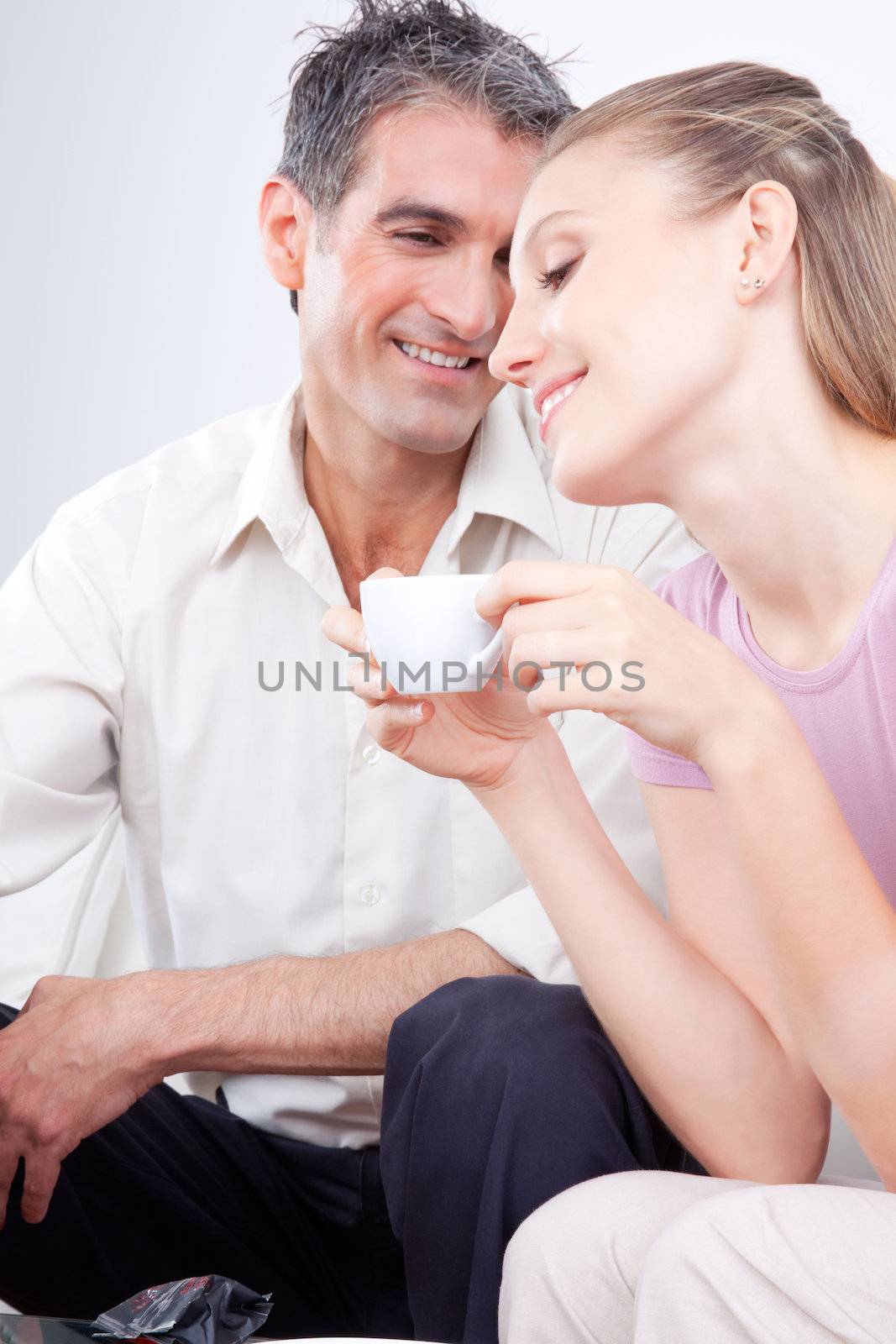Portrait of lovely couple, woman holding cup.