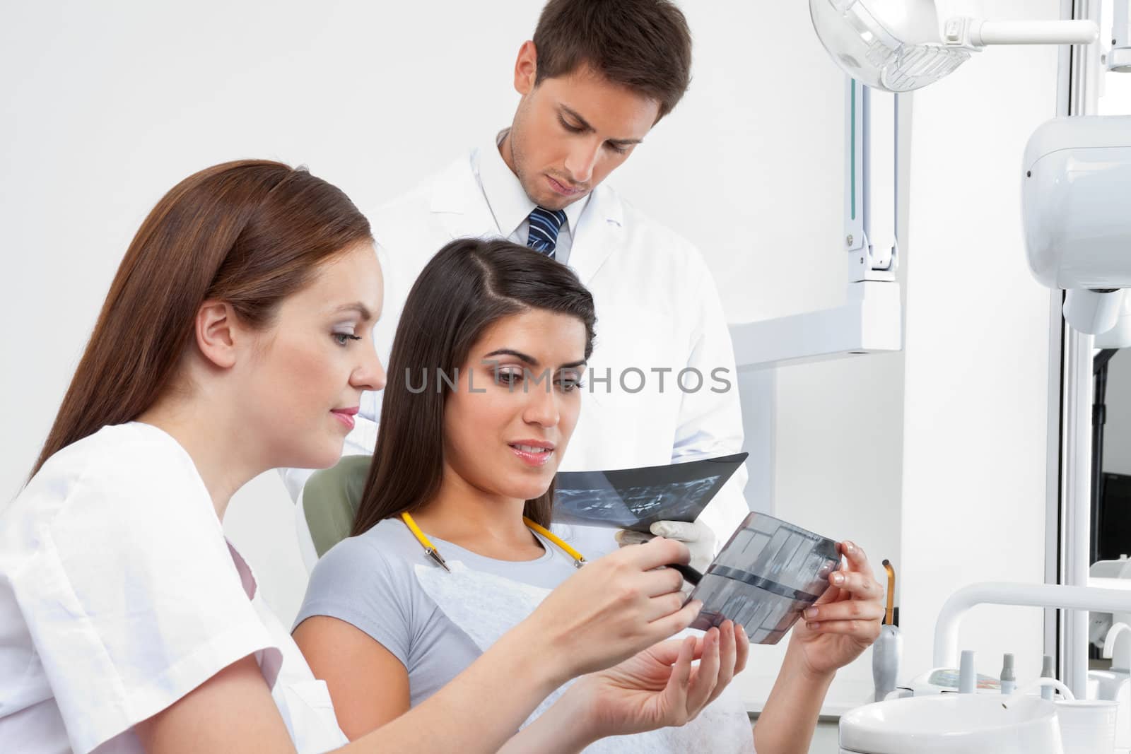Female Nurse Explaining X-Ray Report To Patient by leaf