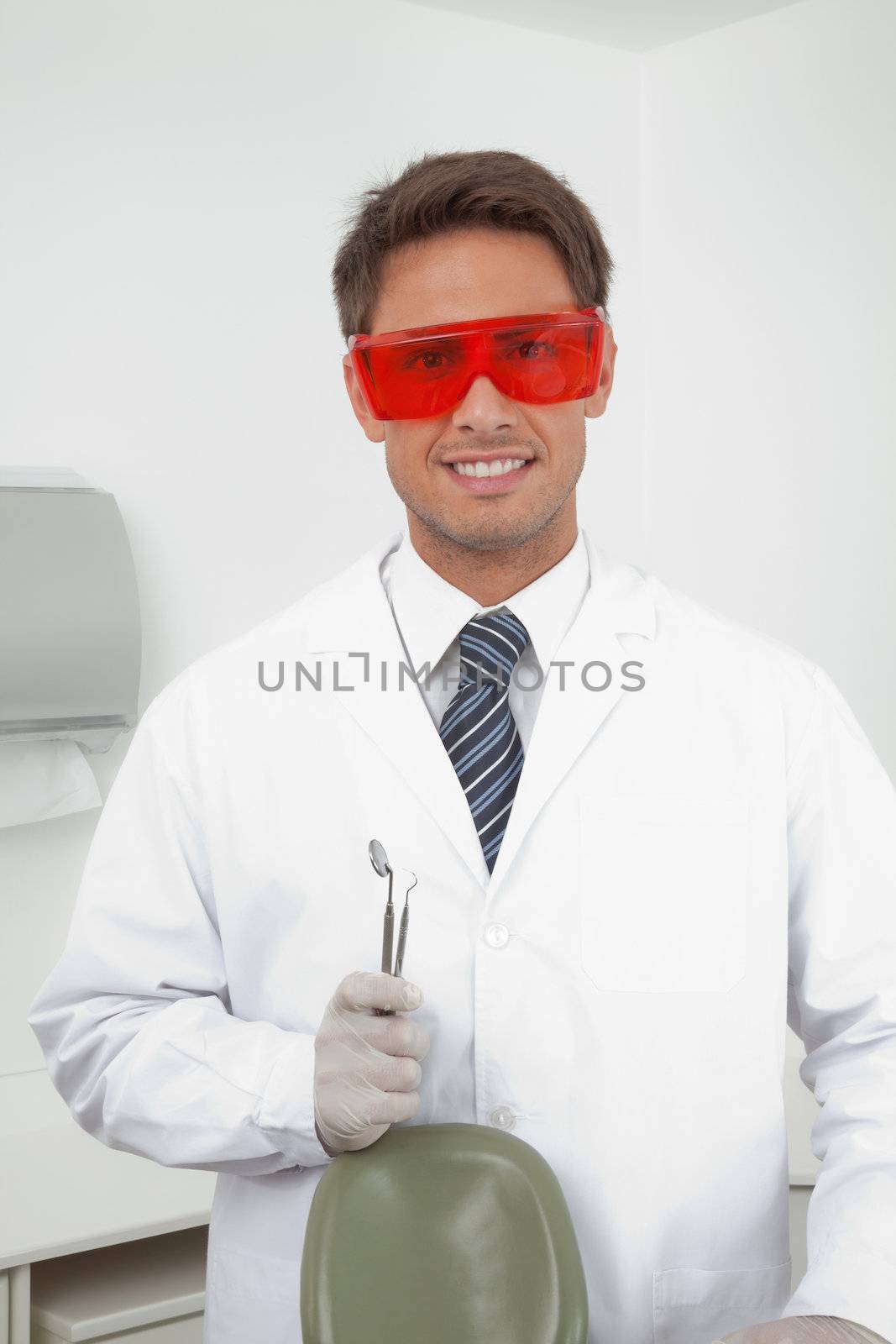 Happy Dentist Holding Tools by leaf