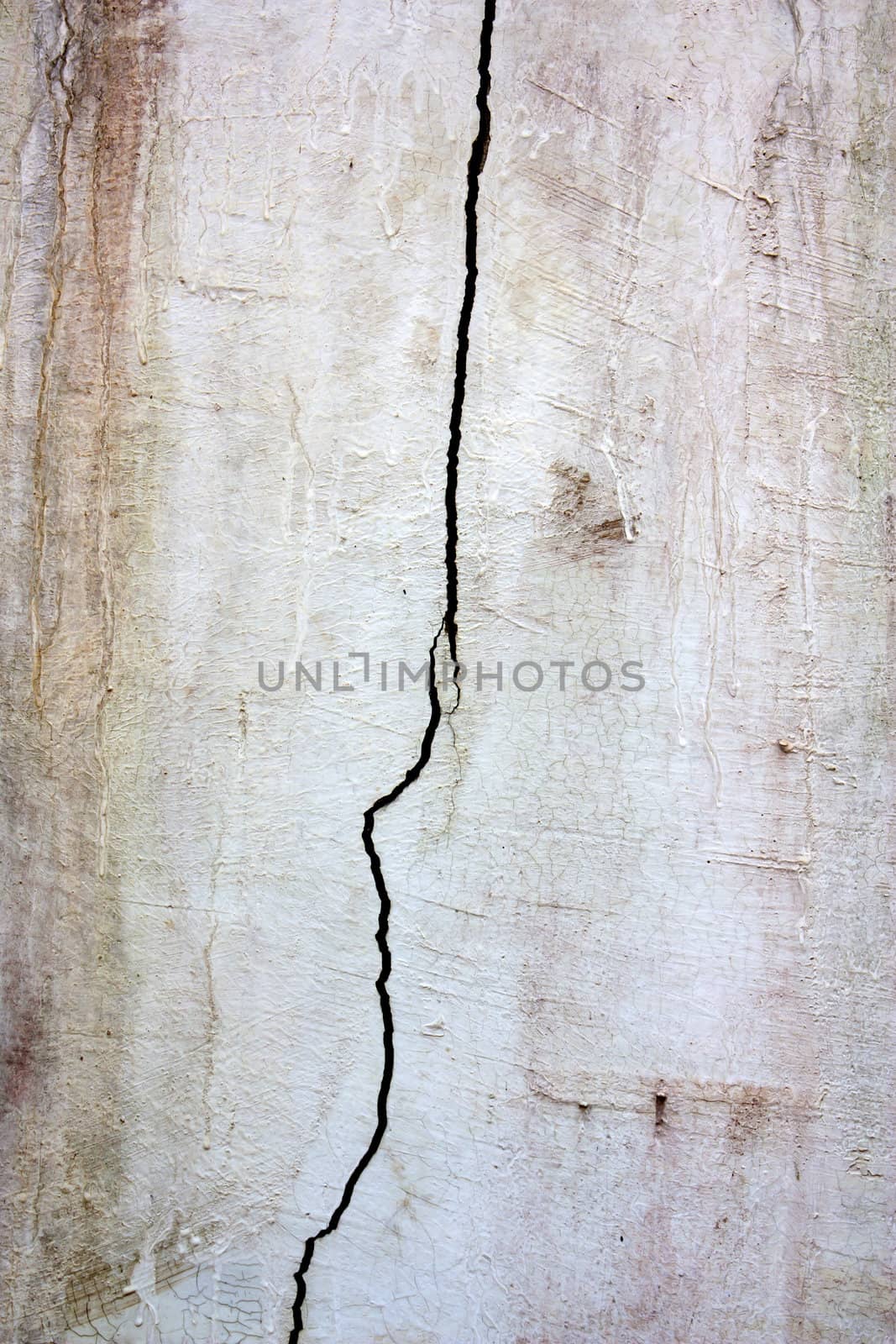 Old cement wall with cracked white wall with cracks.