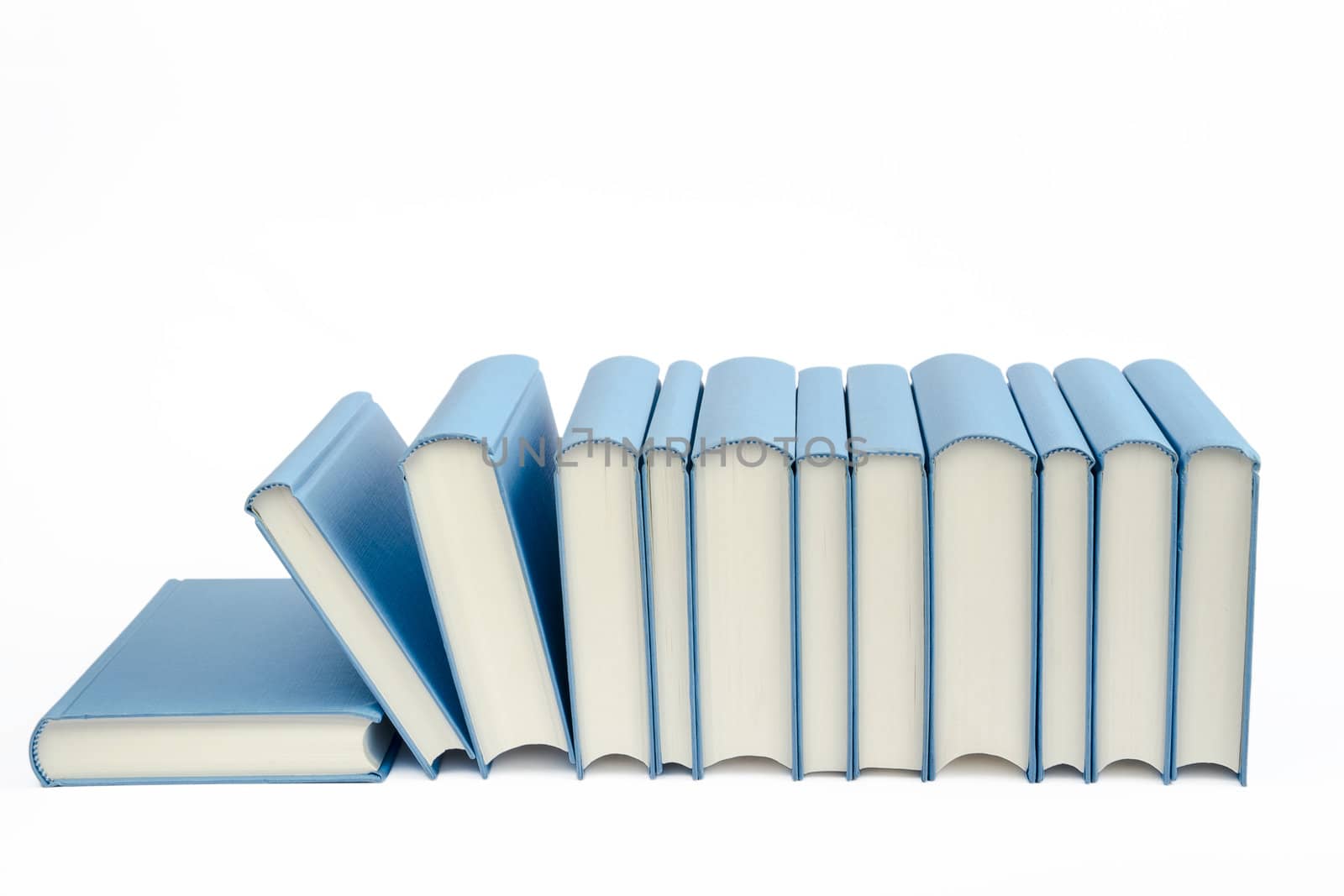 A group of blue books in a row on a white background