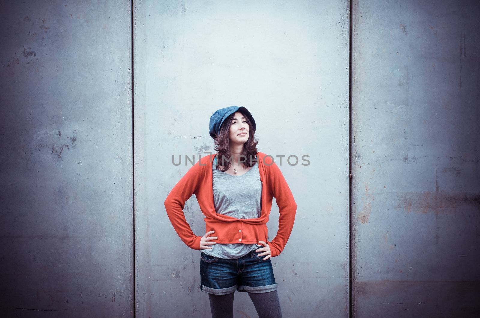 Beautiful stylish woman listening to music in the street 