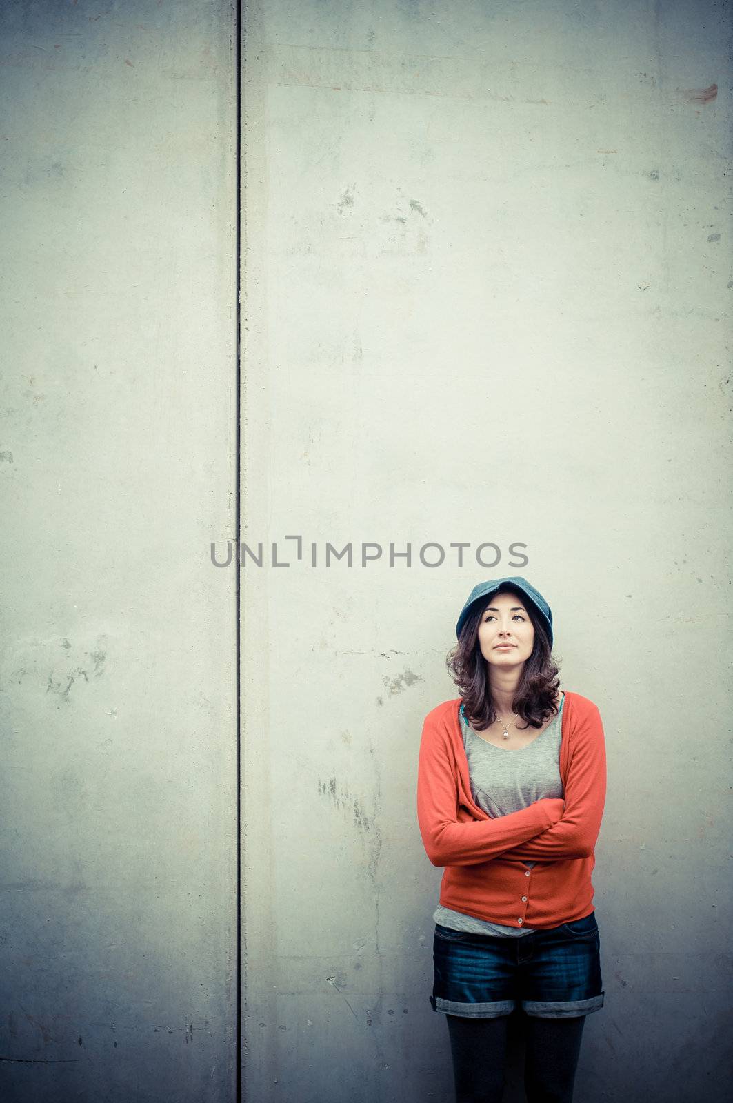 Beautiful stylish woman listening to music in the street 