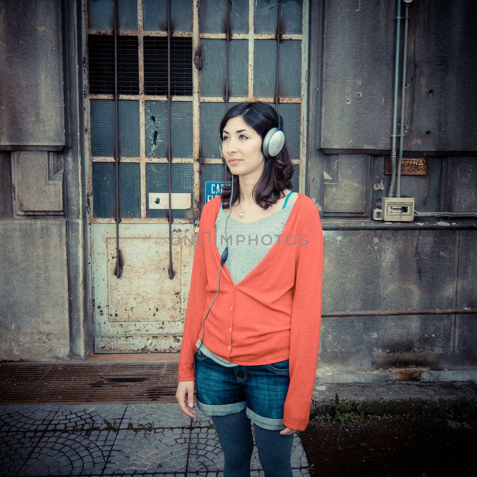 Beautiful stylish woman listening to music by peus