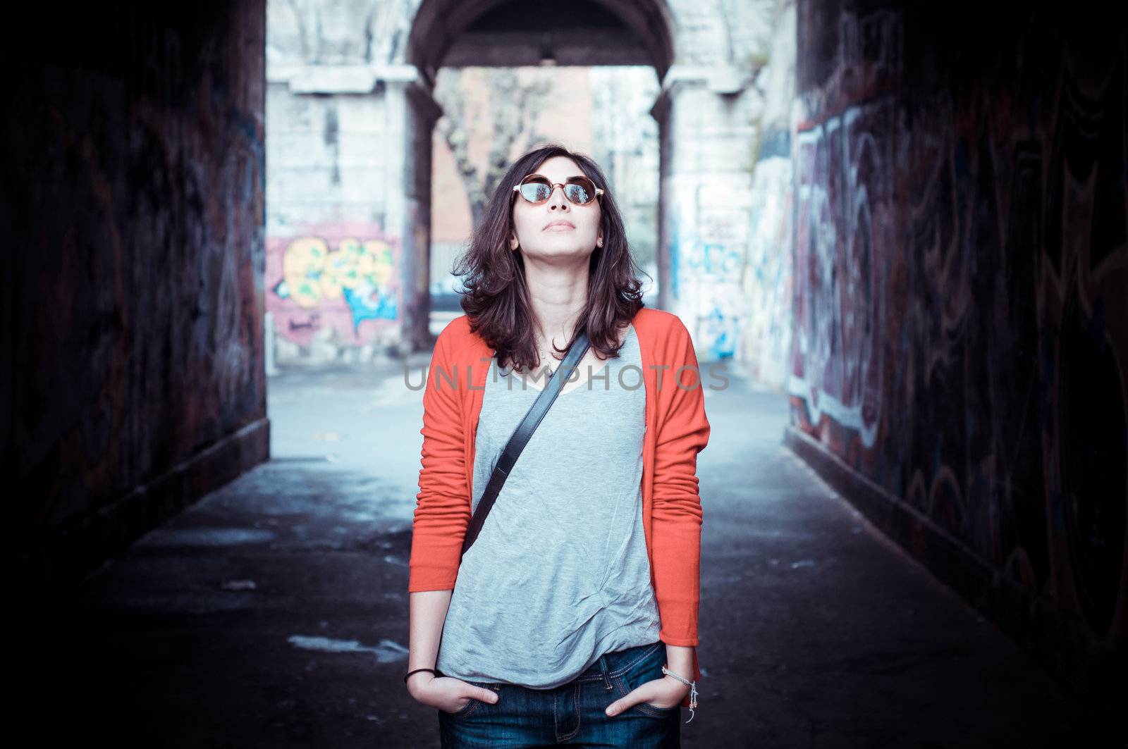 Beautiful stylish woman listening to music in the street 