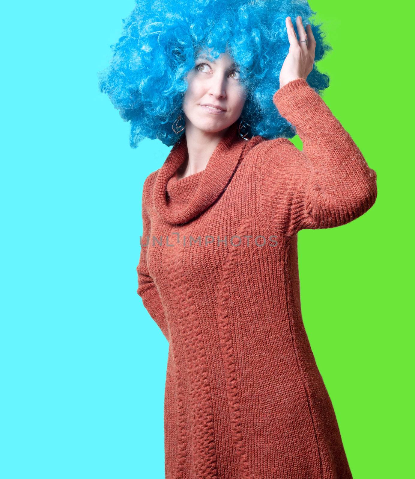 beautiful girl with curly blue wig and turtleneck on colorful background