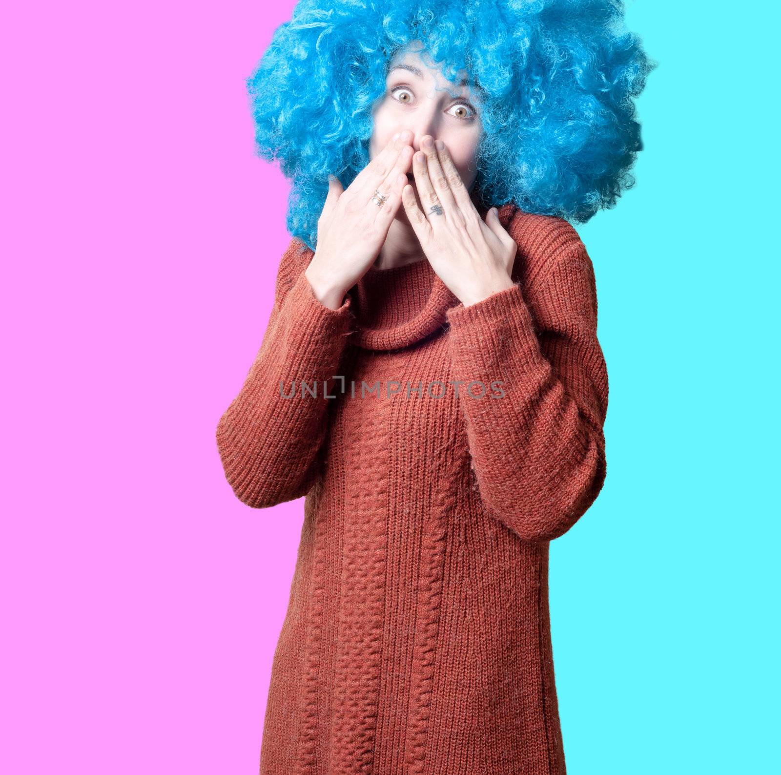 beautiful girl with curly blue wig and turtleneck on colorful background