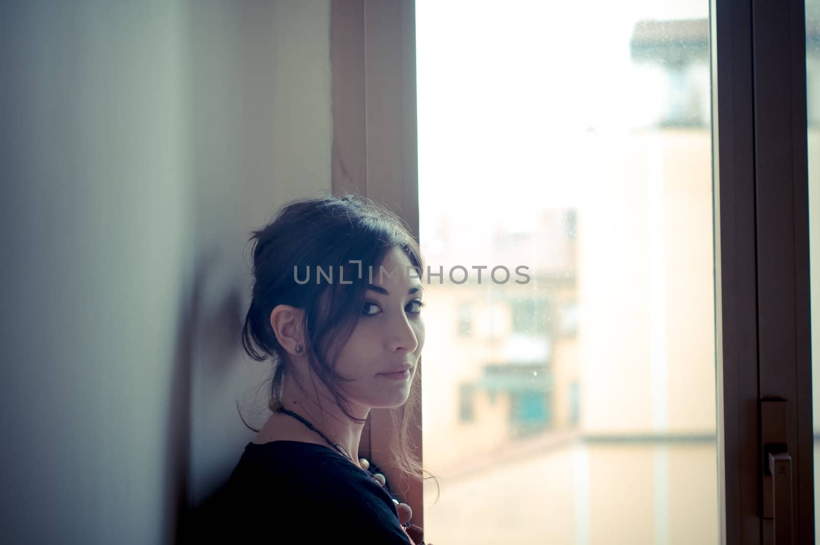 beautiful woman at home near window