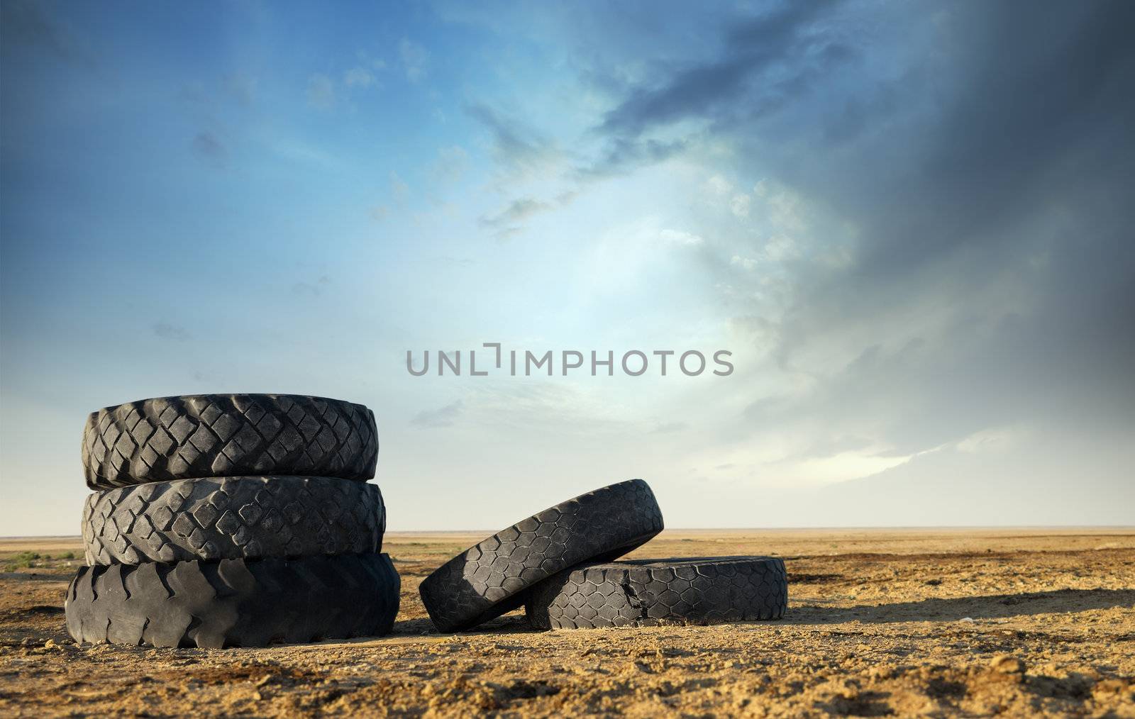 Five abandoned tires outdoors as a symbol of environmental pollution