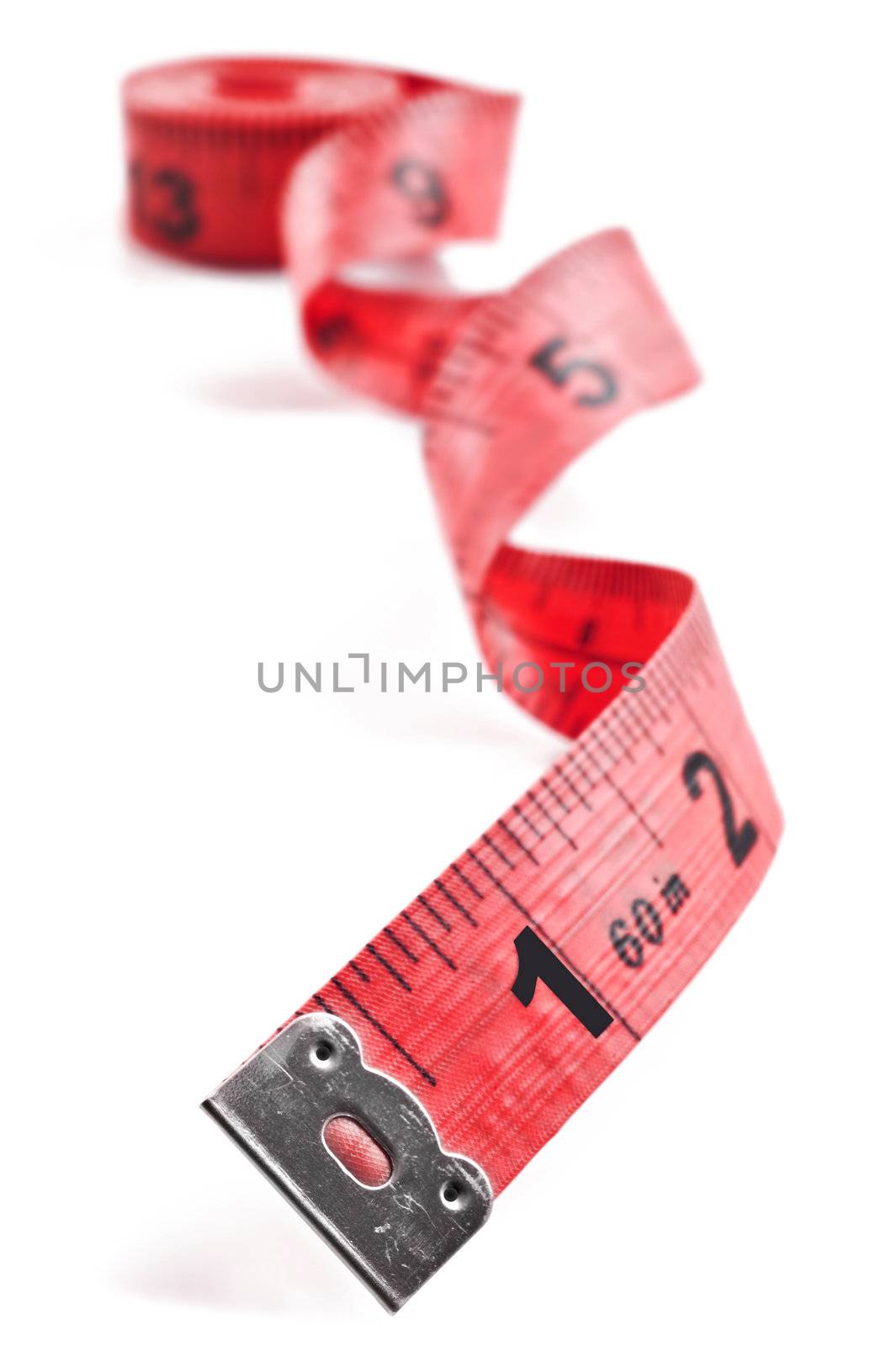 Red tape meassure on rolled up on white background by tish1