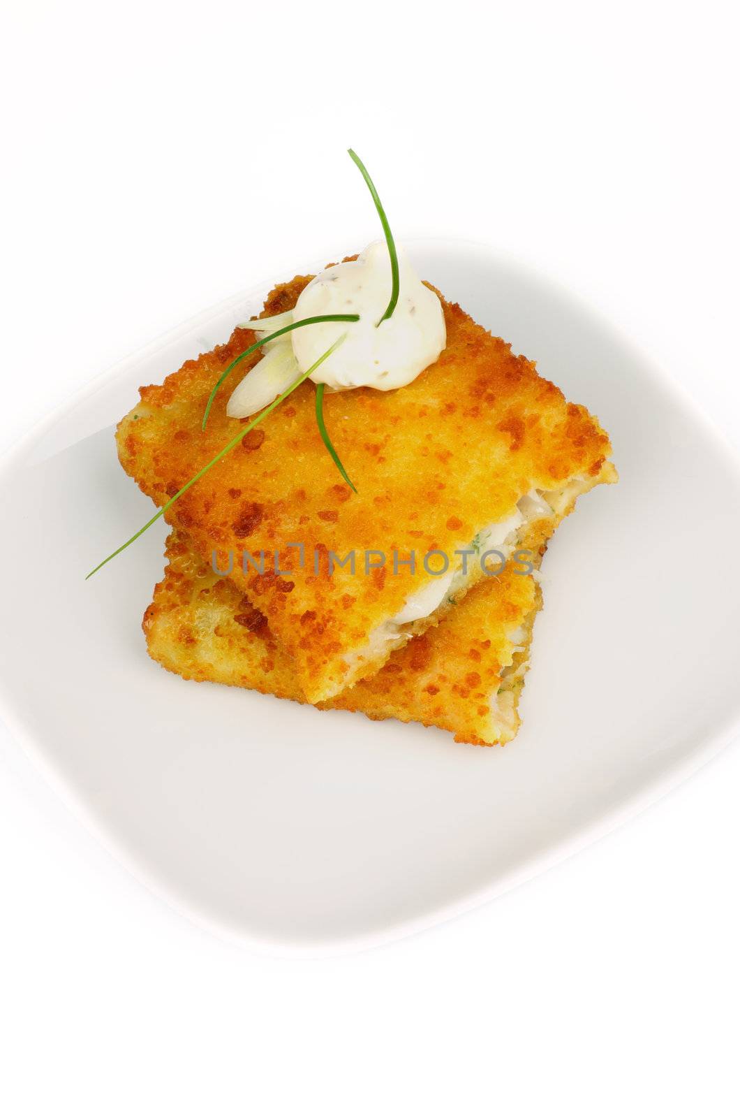 Breaded Сod Fillet with Spring Onion and Tartar Sauce on White Plate. Top View