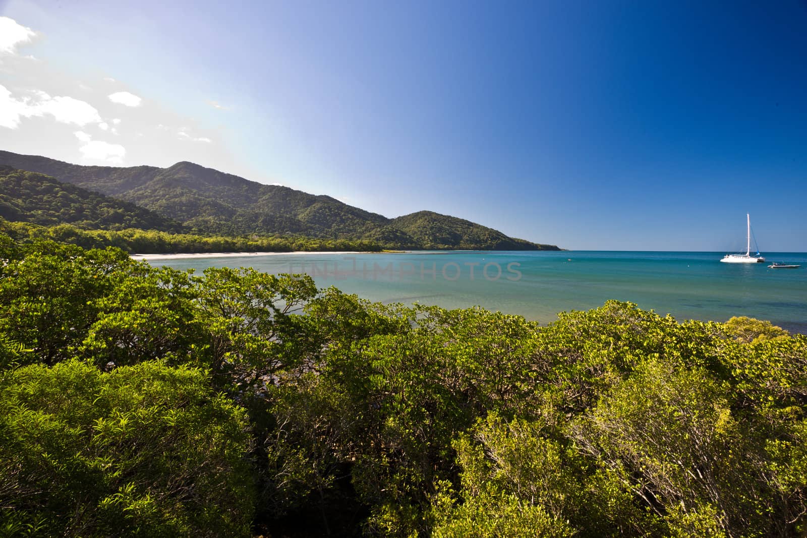 Tropical beach with yacht in a landscape view