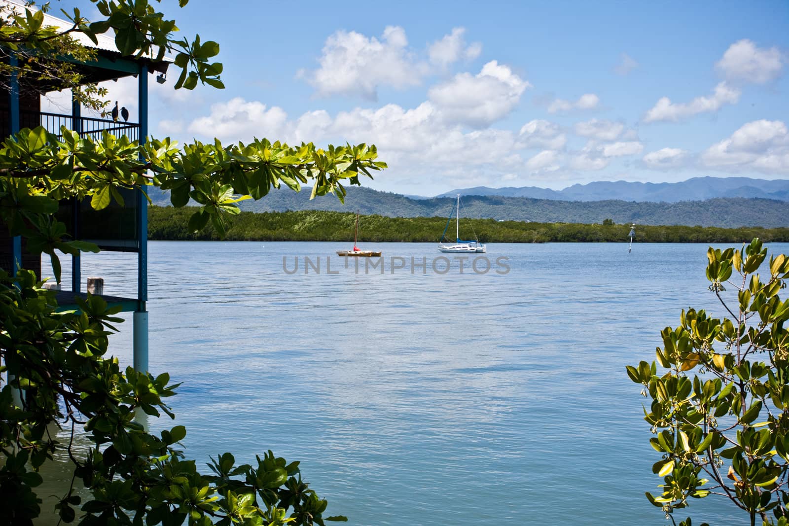 Beautiful seascape with boat and mountains under the blue sky