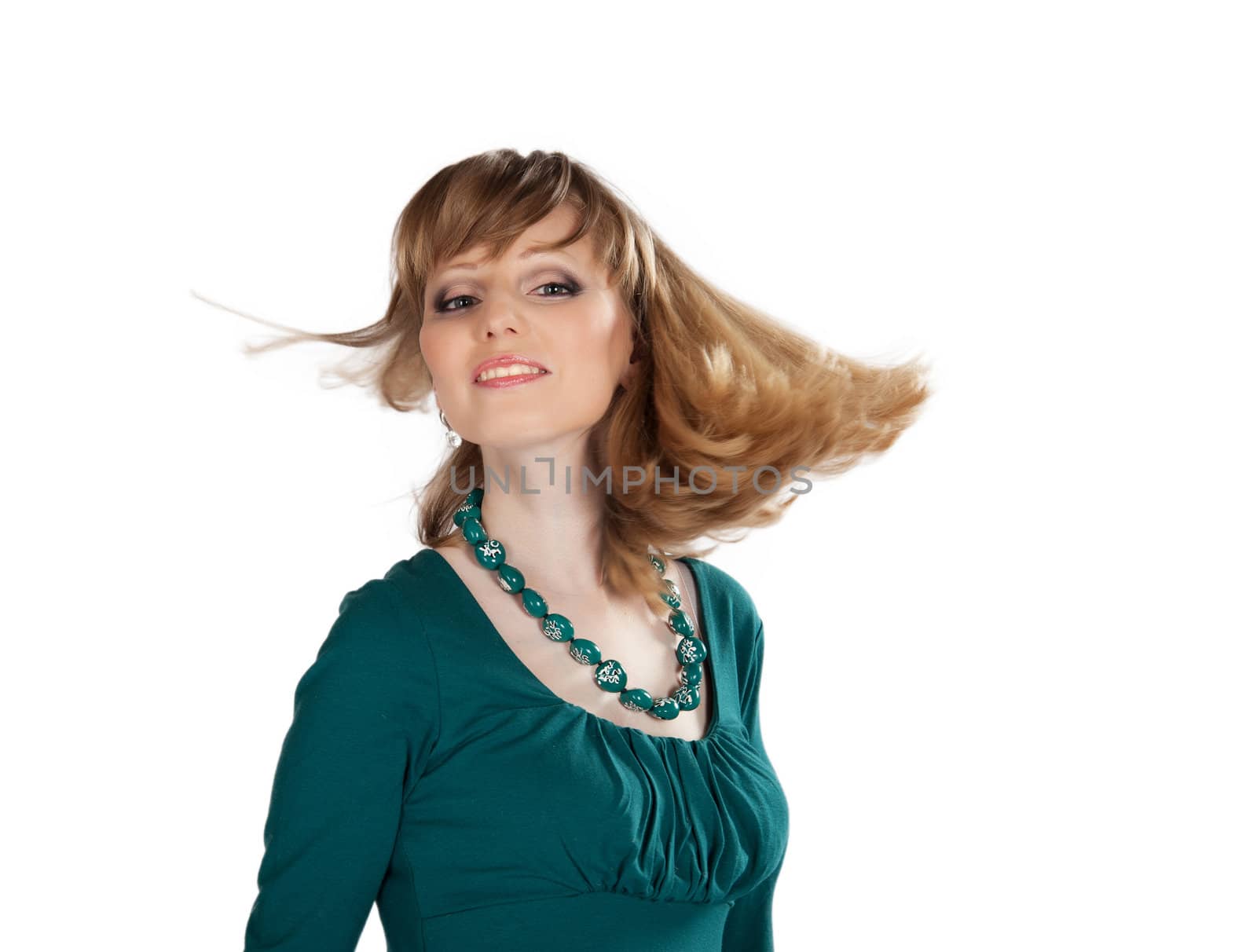 beautiful blond girl in a green dress twirls hair