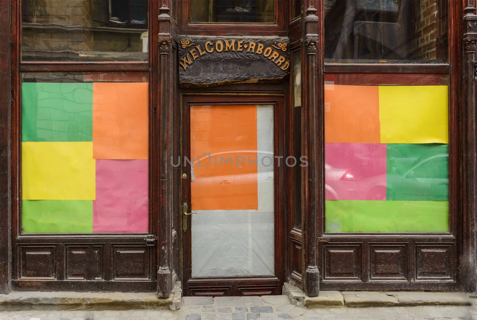 colored wooden facade with wellcomeing message