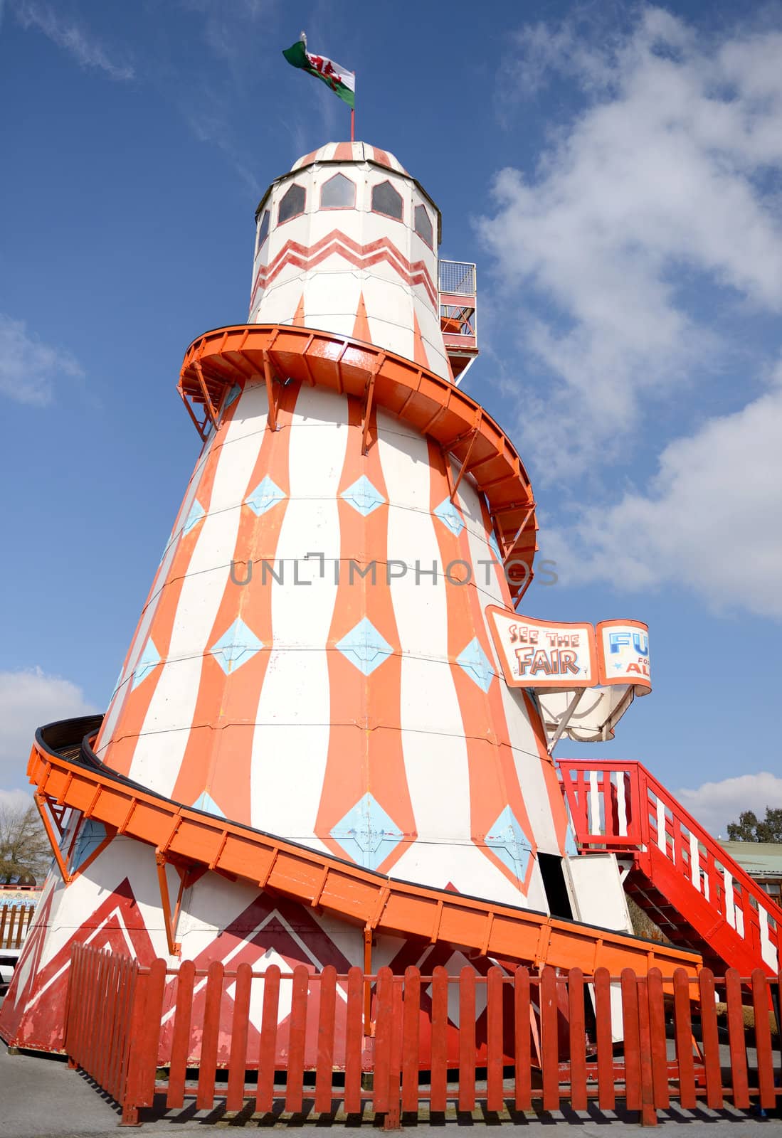a fun helter skelter at a fairground on a sunny day
