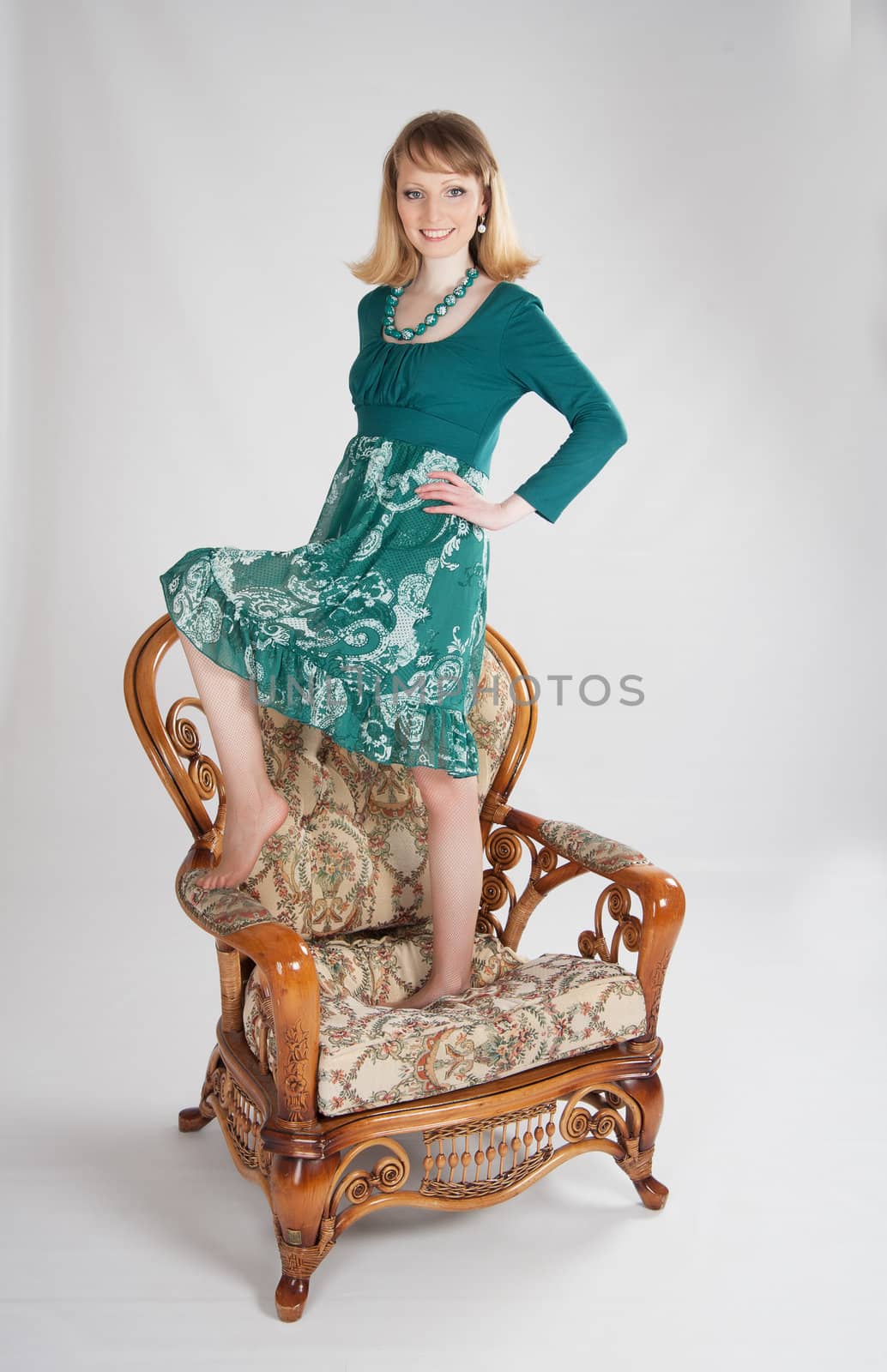 l woman in a green dress sitting on a chair by raduga21