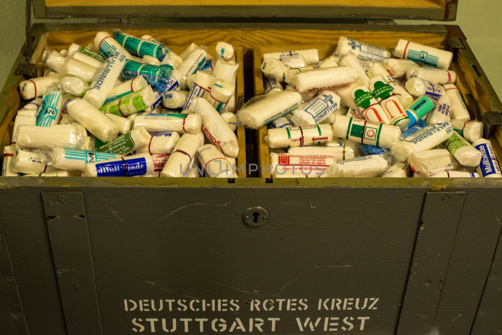 STUTTGART, GERMANY - April 14, 2013: Old bandage and first aid materials in a box of the German Red Cross on display at a safety precautions presentation in the Pragsattel high-rise bunker in Stuttgart, Germany on April 14, 2013. The materials were stored in the bunker in case they would be needed during an emergency stay in the safety building.
