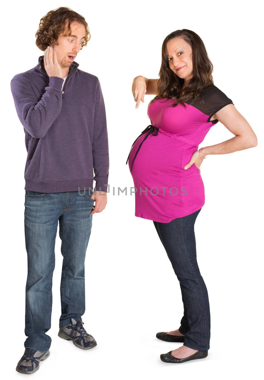 Pregnant woman pointing at womb next to surprised man