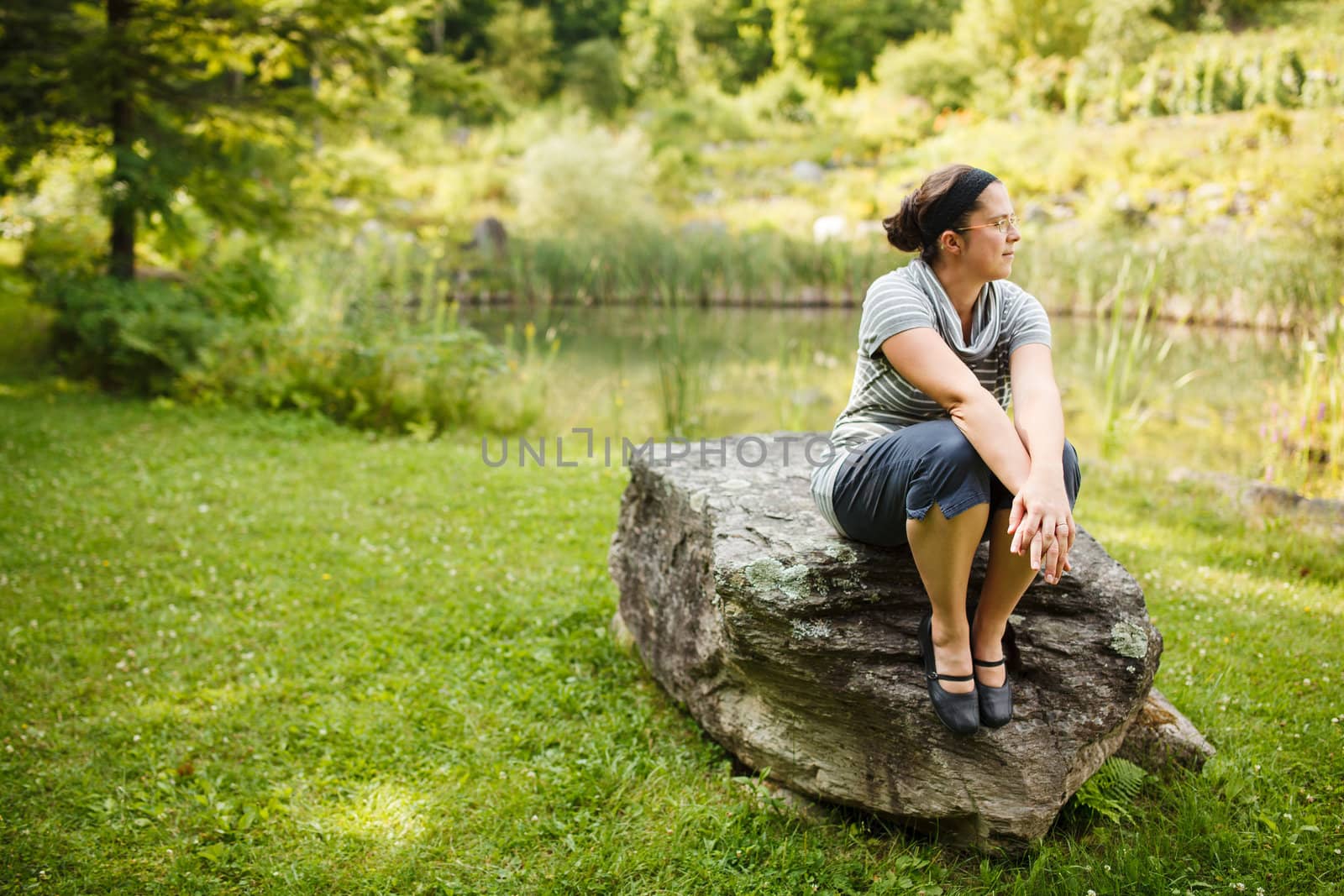 Woman sitting on a rock by Talanis