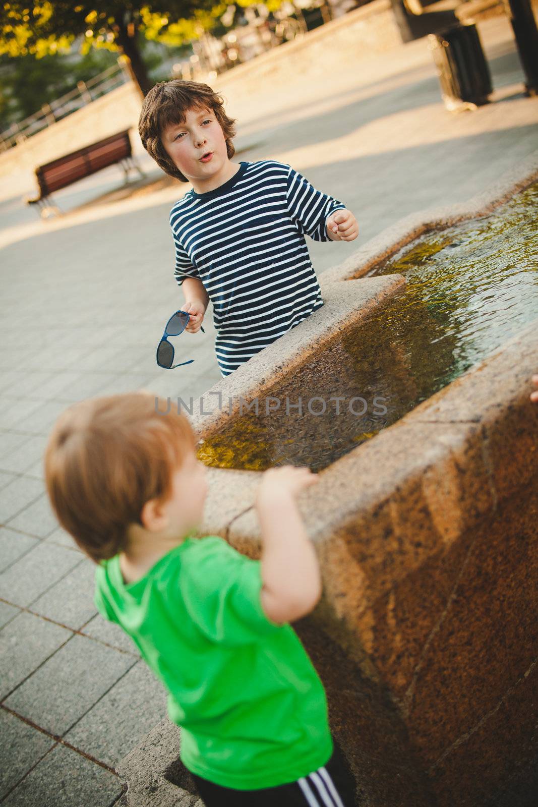 Boy talking near a fountain