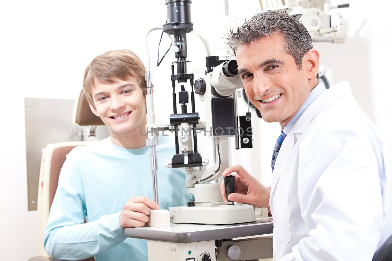 Optometrist And Pateint In Clinic by leaf