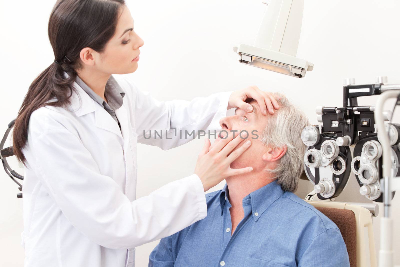 Optometrist taking an eyesight test examination.