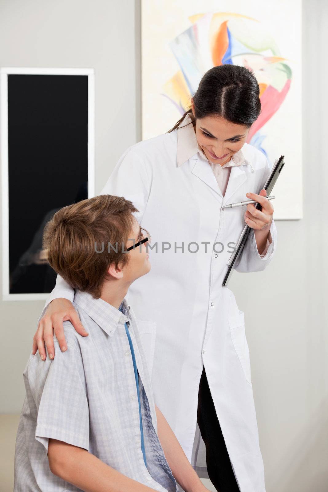 Teenage boy with glasses consulting to an eye specialist at the clinic