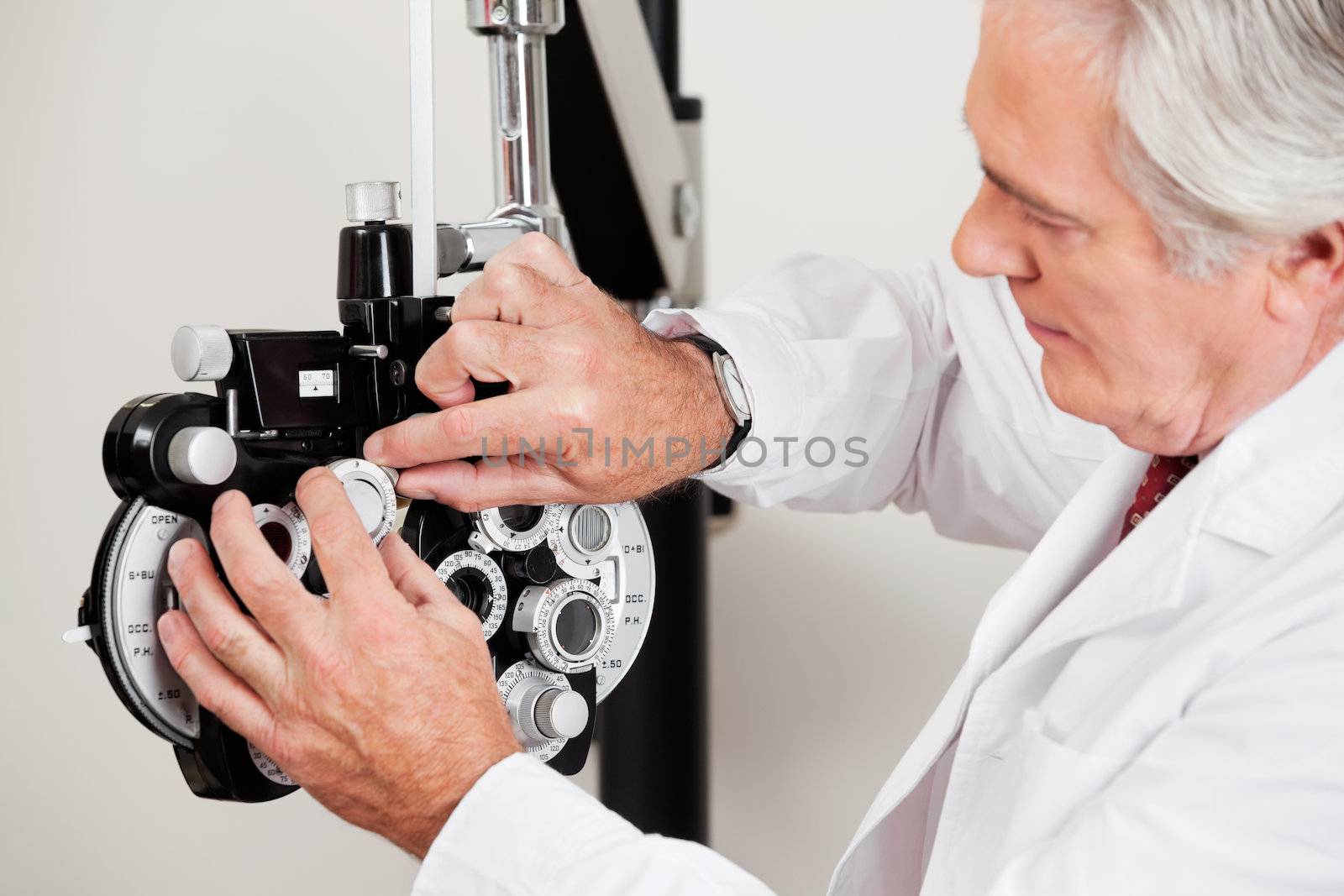 Optometrist changing lens in phoropter for eye examination