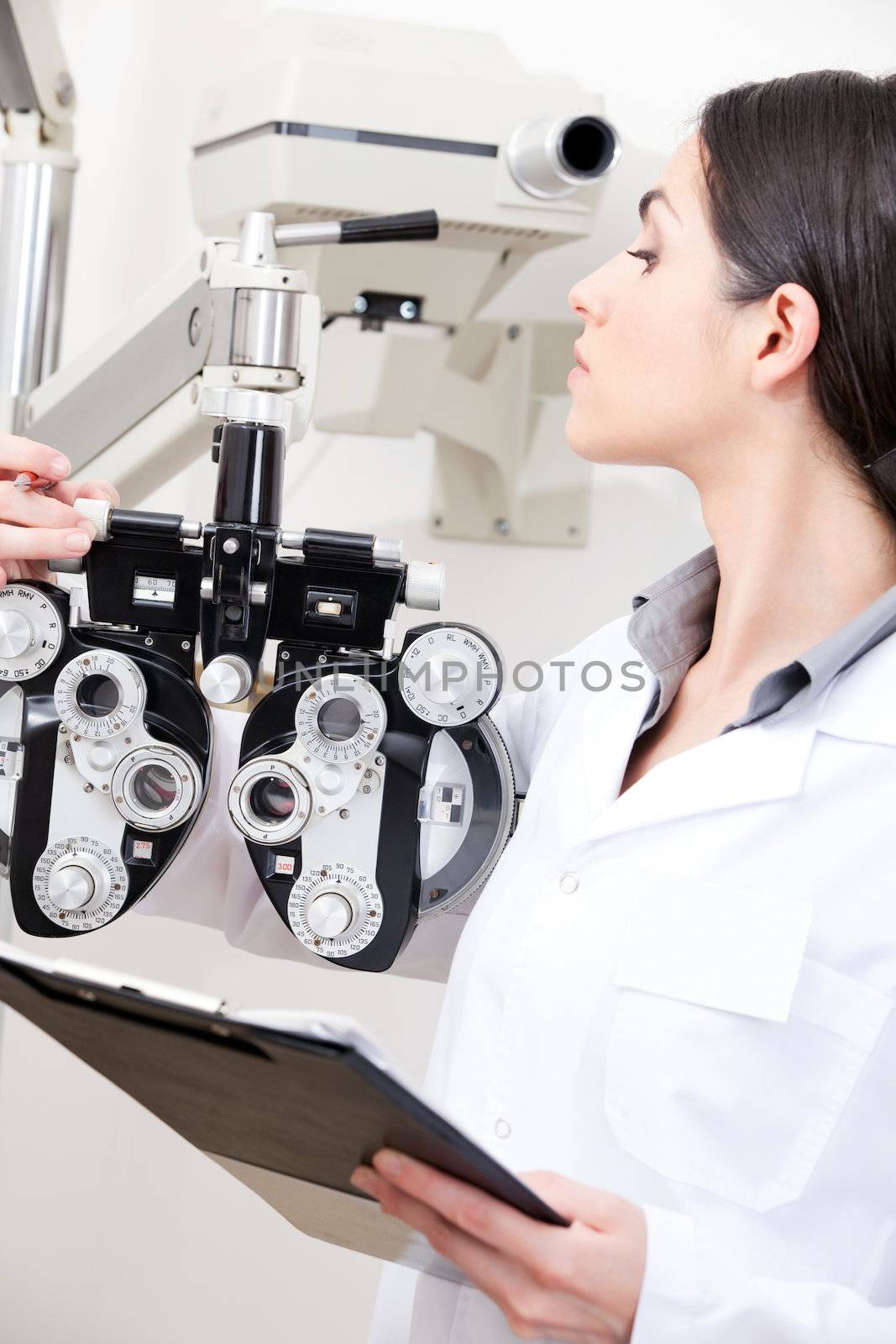 Optometrist Looking At Phoropter by leaf