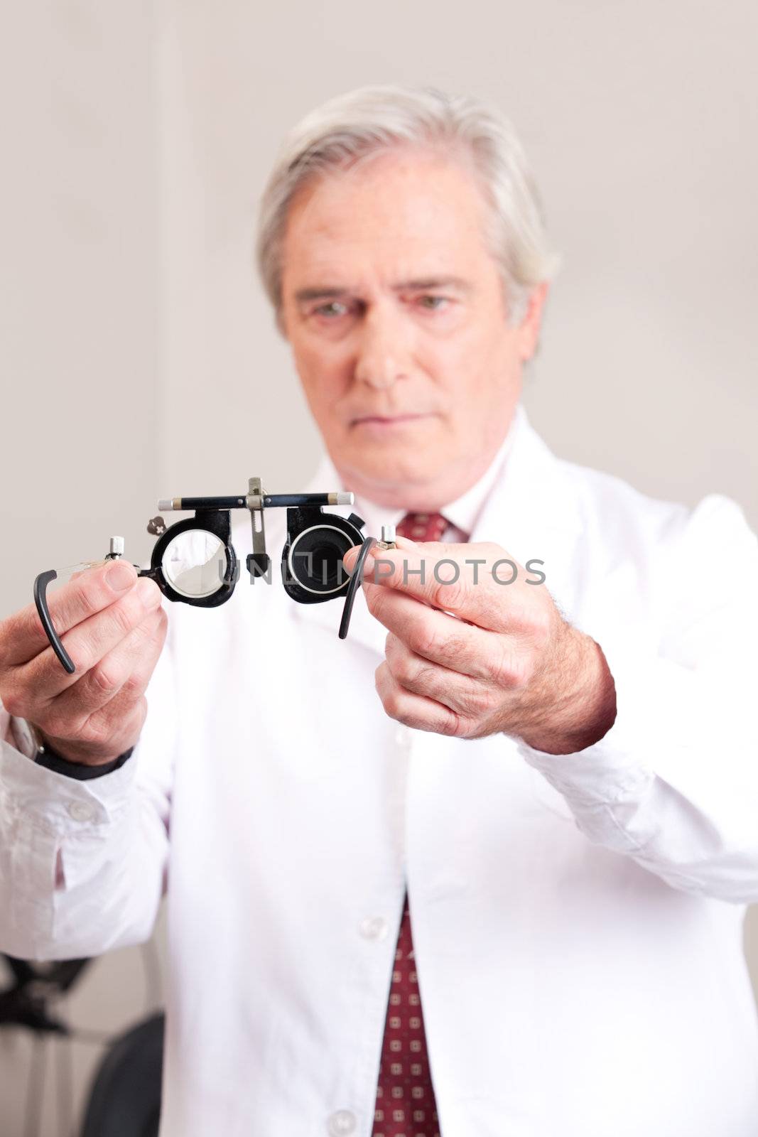 Optometrist holding a eye test glasses.