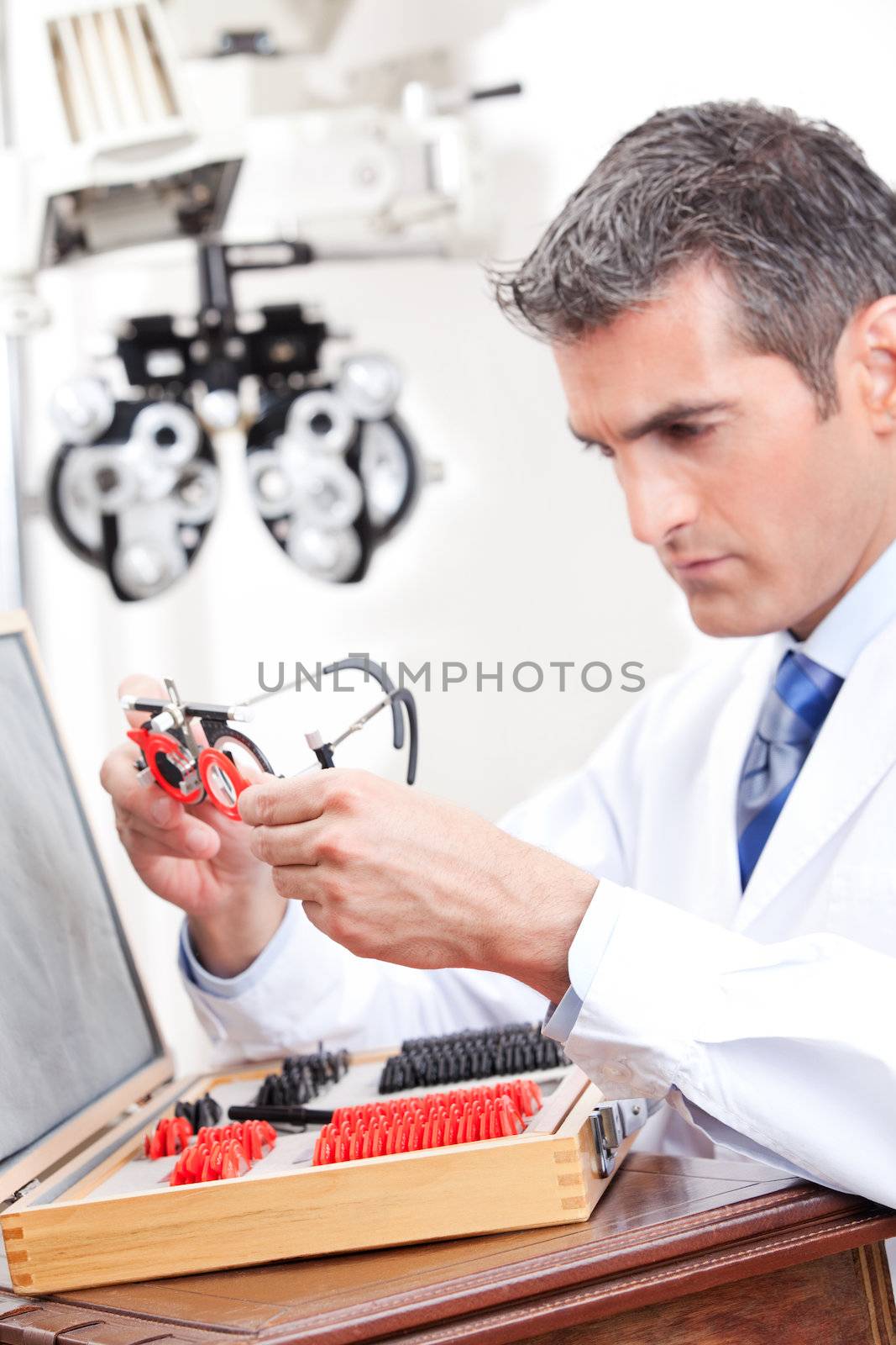 Optometrist looking at measuring eye glasses.