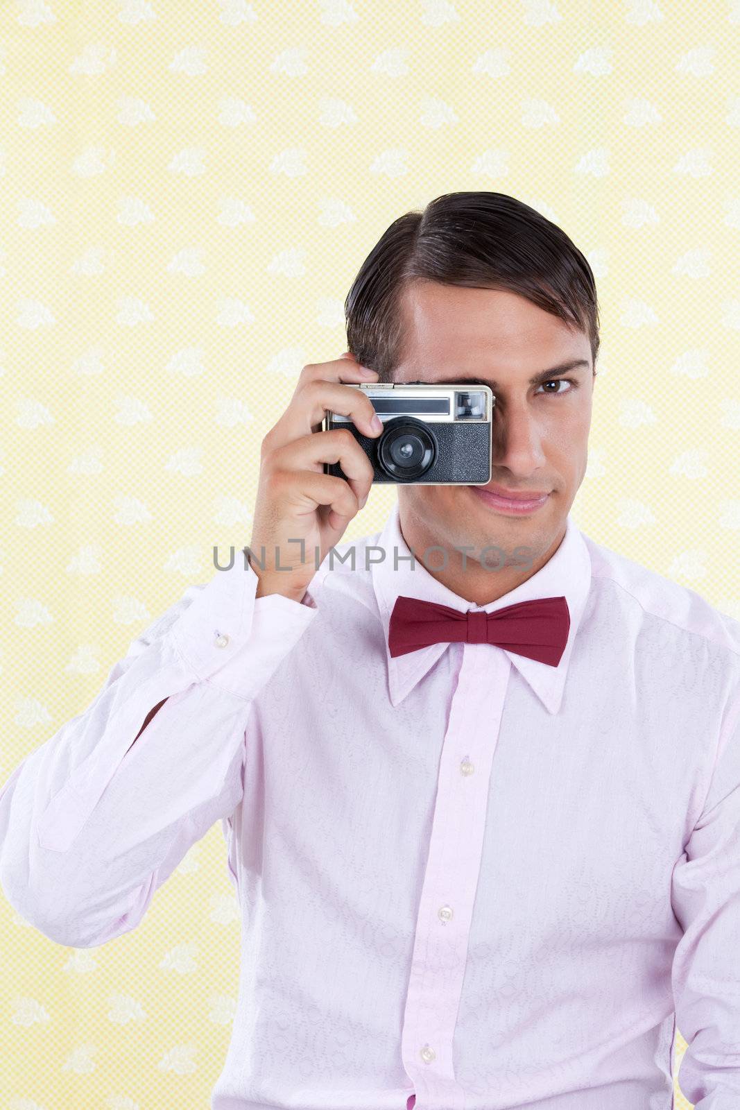 Male using old retro camera, looking at viewer