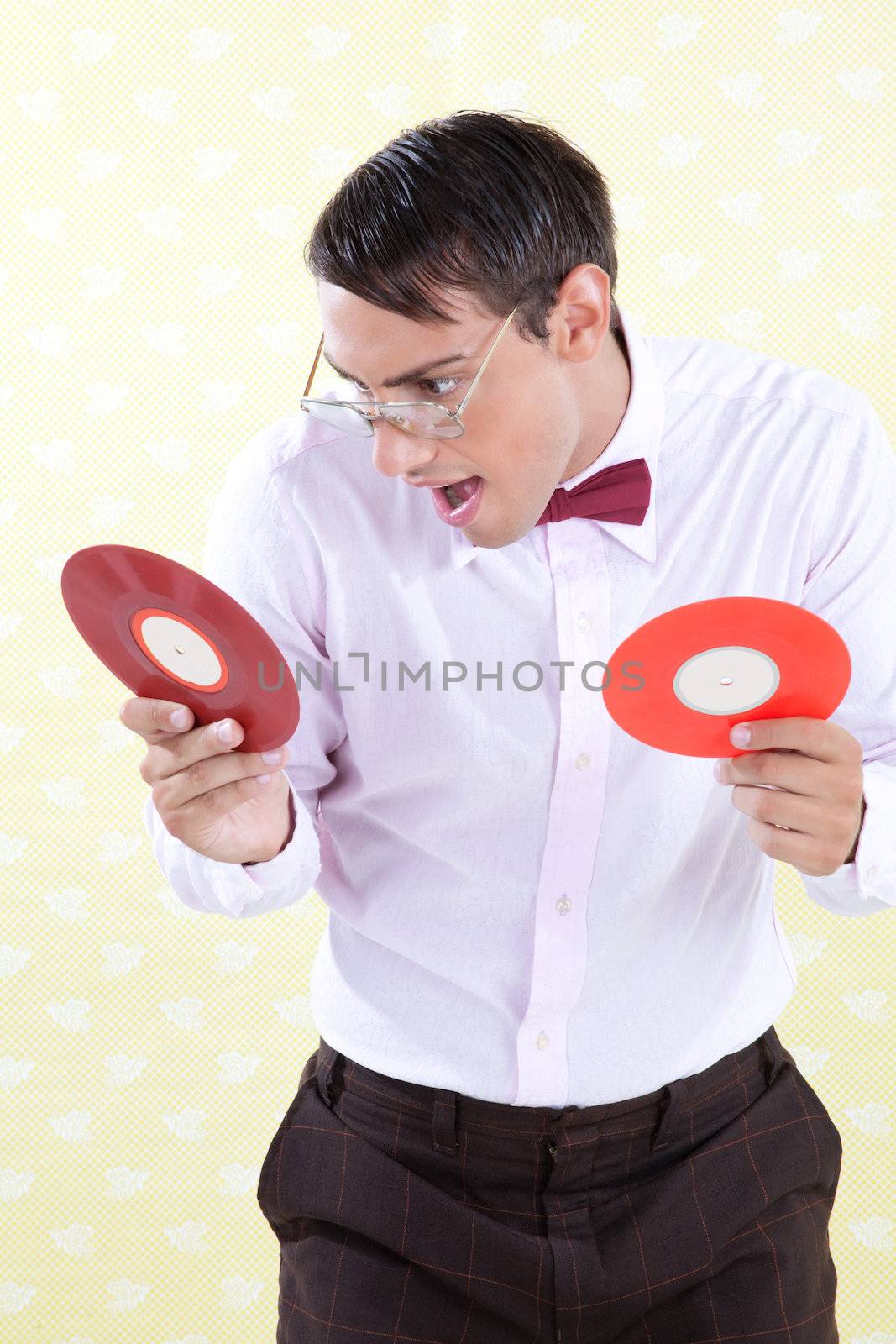 Man looking at vinyl record with excited expression