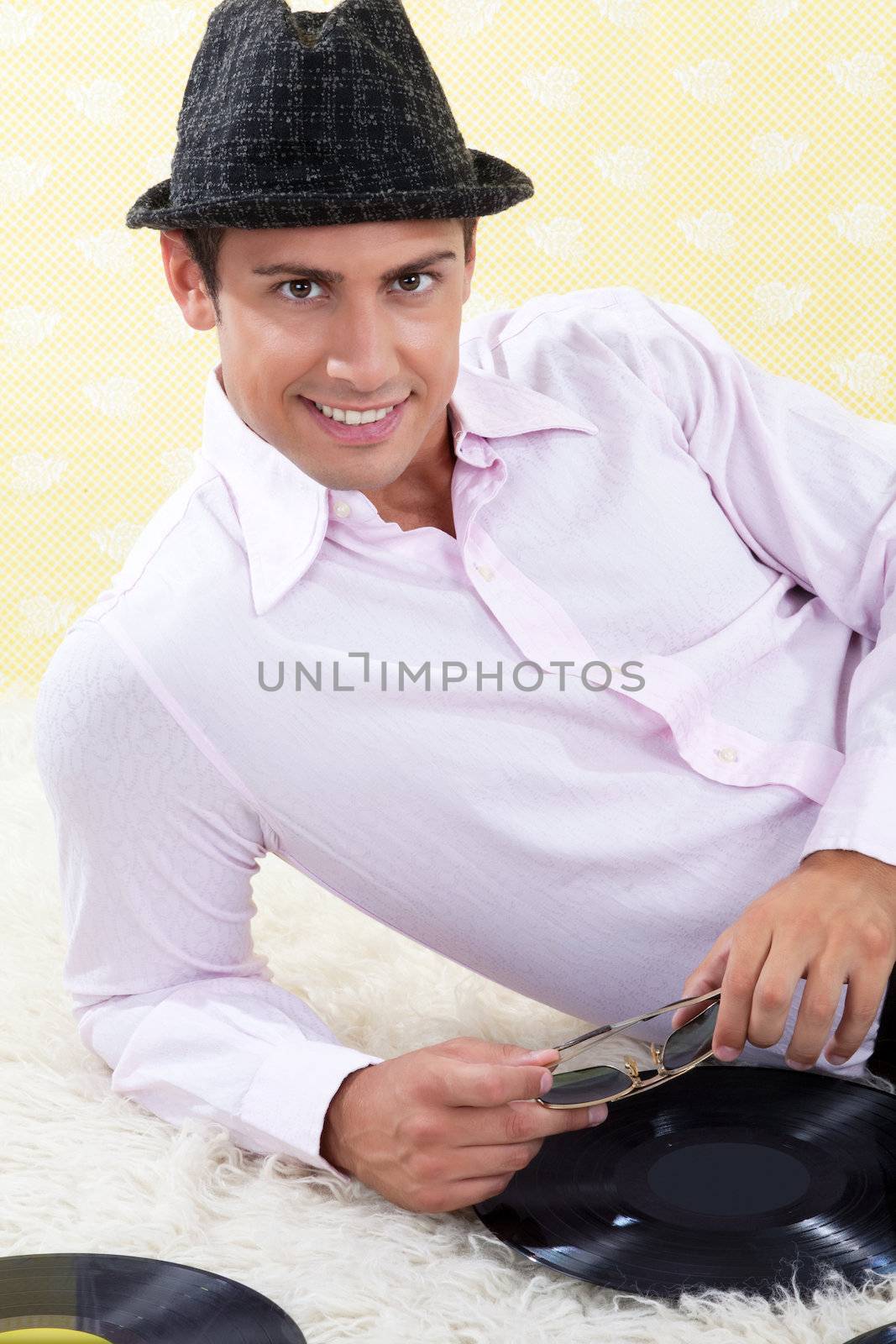 Man with vinyl record on white carpet.