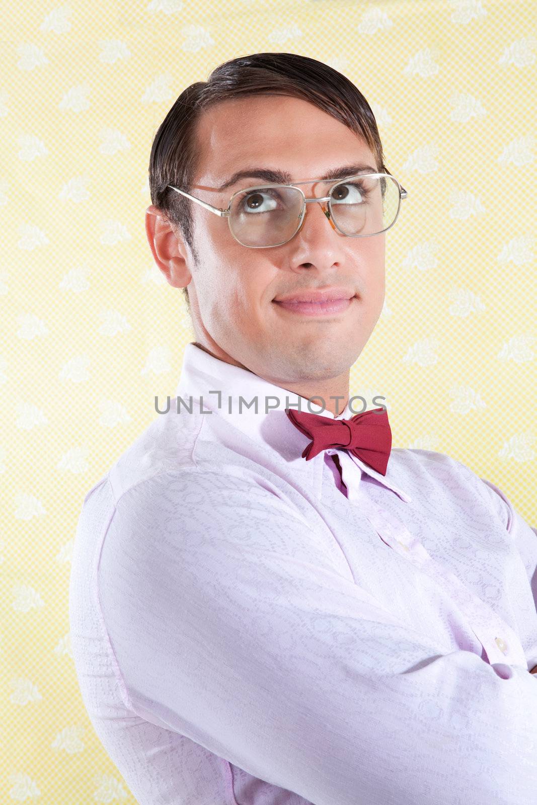 Portrait of thoughtful nerd styled  man on wallpaper.