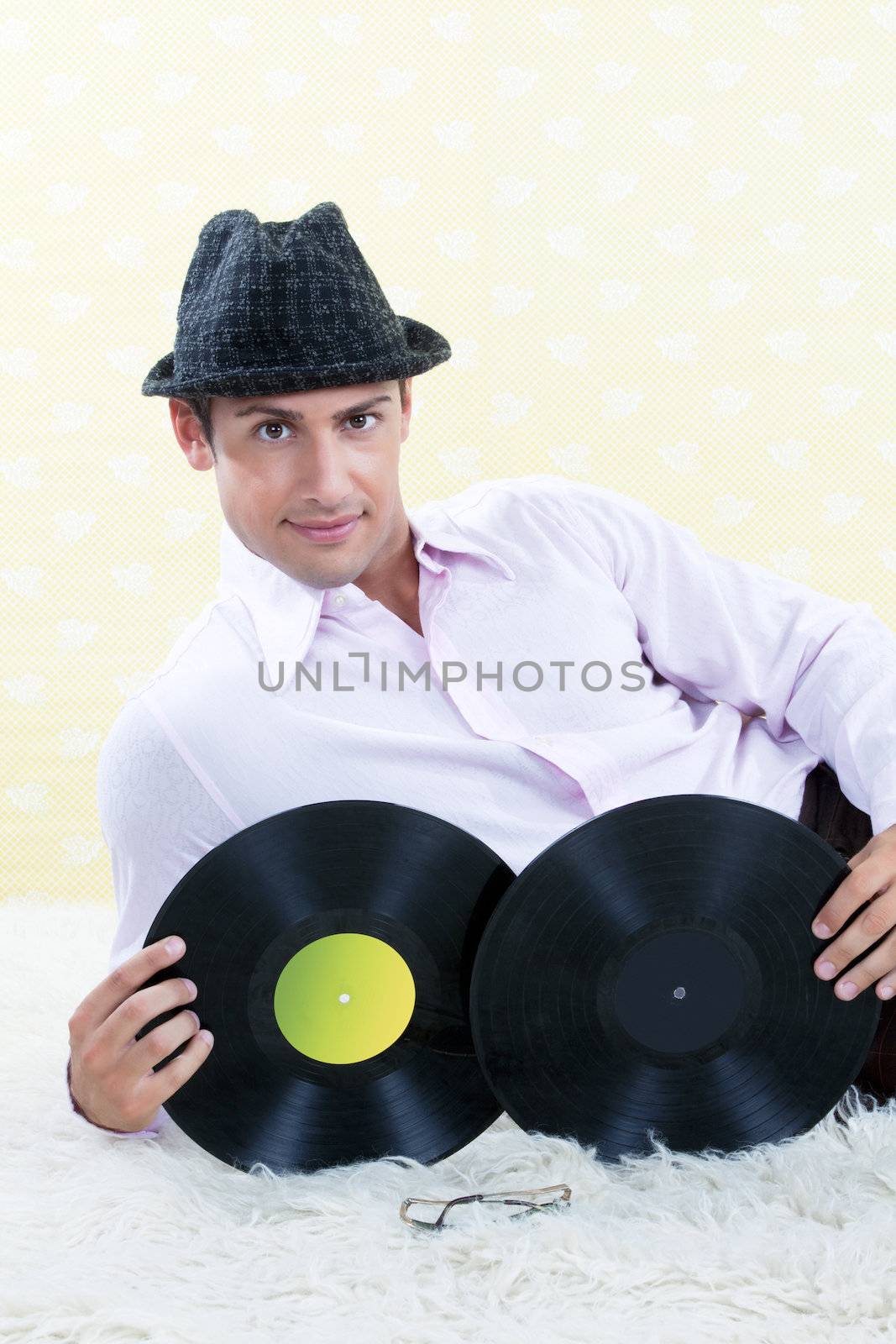 Man posing with vinyl records in studio